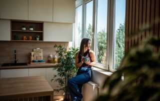 Woman biohacking her morning habits, eating while looking outside