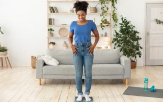 Woman on scales measuring weight loss